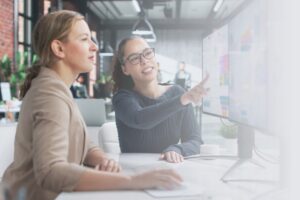 Two women looking at a computer screen